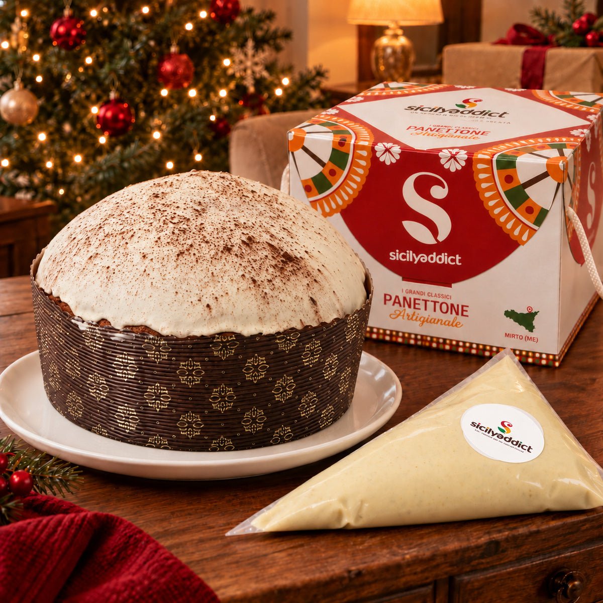 Panettone al Tiramisu' accanto alla confezione regalo e alla crema separata.