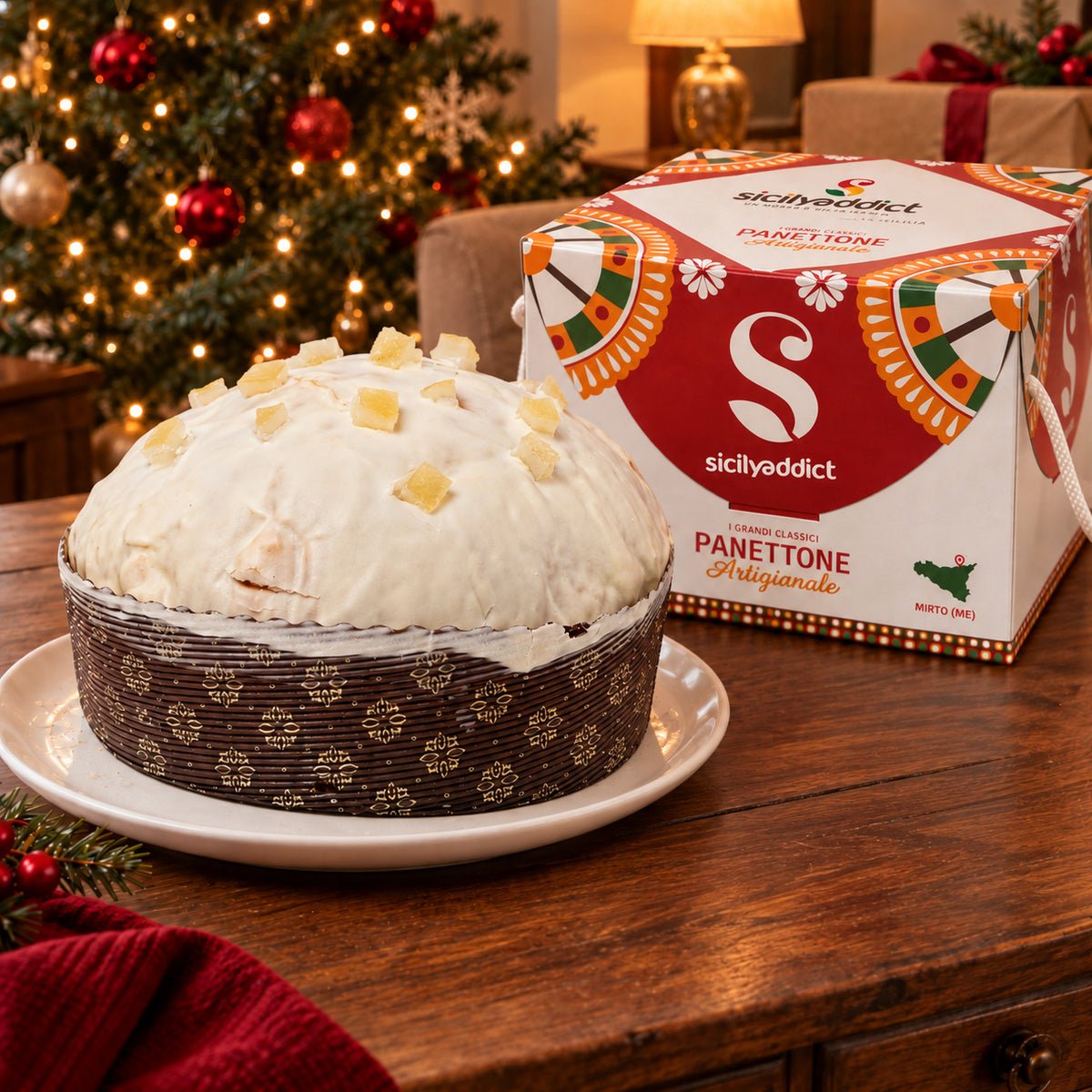 Panettone Limone e Cioccolato Bianco accanto alla confezione regalo.